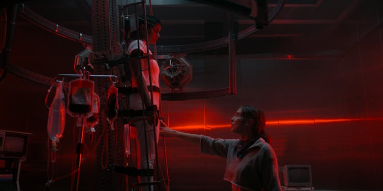 Two characters in an eerie red world.