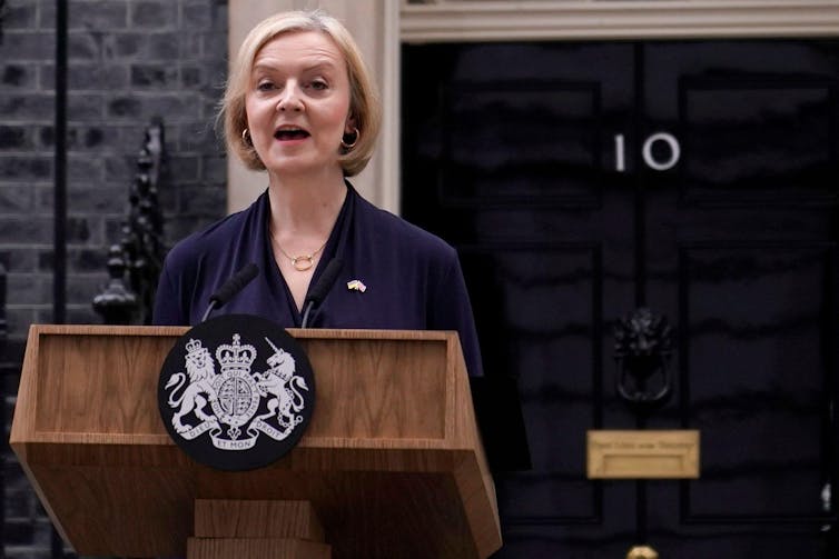 Liz Truss resigning outside 10 Downing Street.