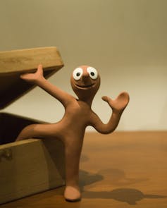 An animated character made of Plasticine with big round eyes.