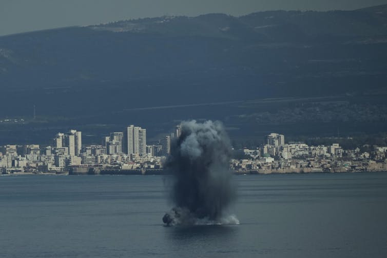 An incoming missile crashes into the sea off the port of Haifa in Israel as Iran retaliates.