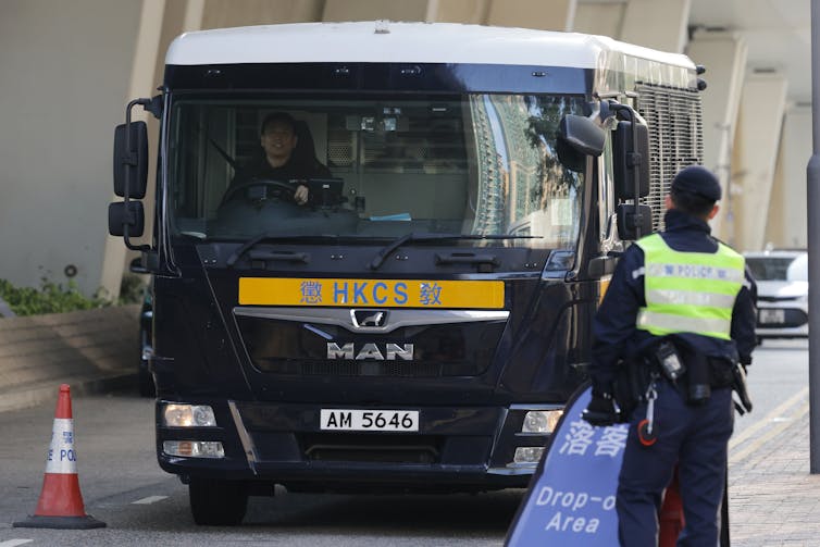 A Hong Kong prison van pulls up in a street in Kowloon.