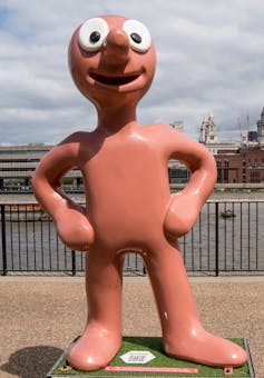 A large model of a Plasticine character with big googly eyes.