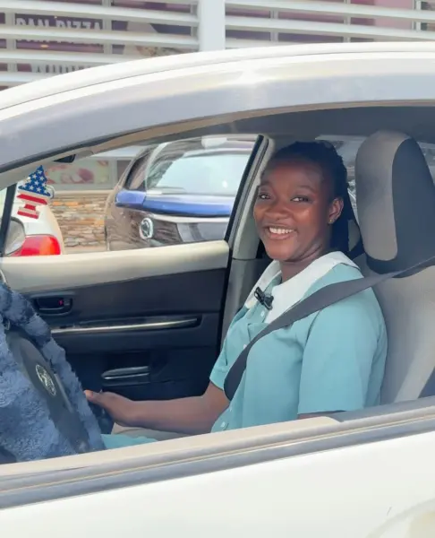An African woman driving a car