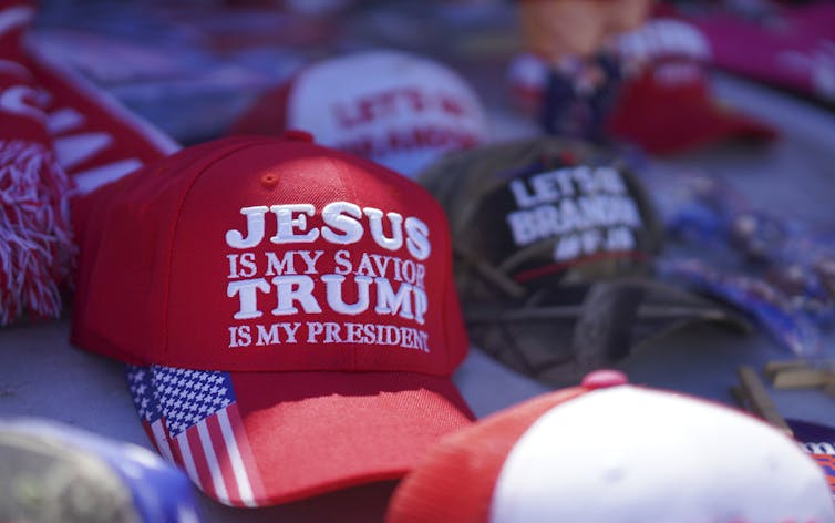 A red hat with the words: Jesus is my saviour, Trump is my president.