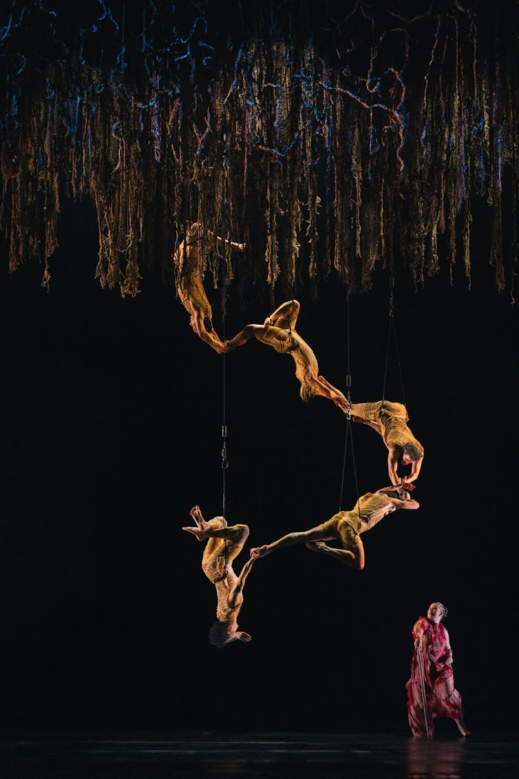Five dancers suspended from the ceiling.