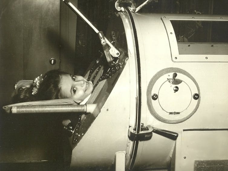a little girl in an iron lung
