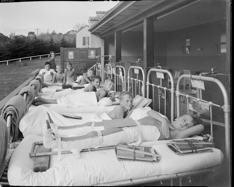boys in hospital beds with blackboard