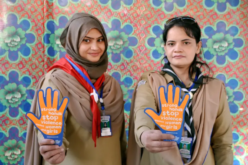 Girl Scouts in Balochistan, Pakistan hold signs that say “say ‘strong hands stop violence against women and girls.” Image from UN Women Flickr. 