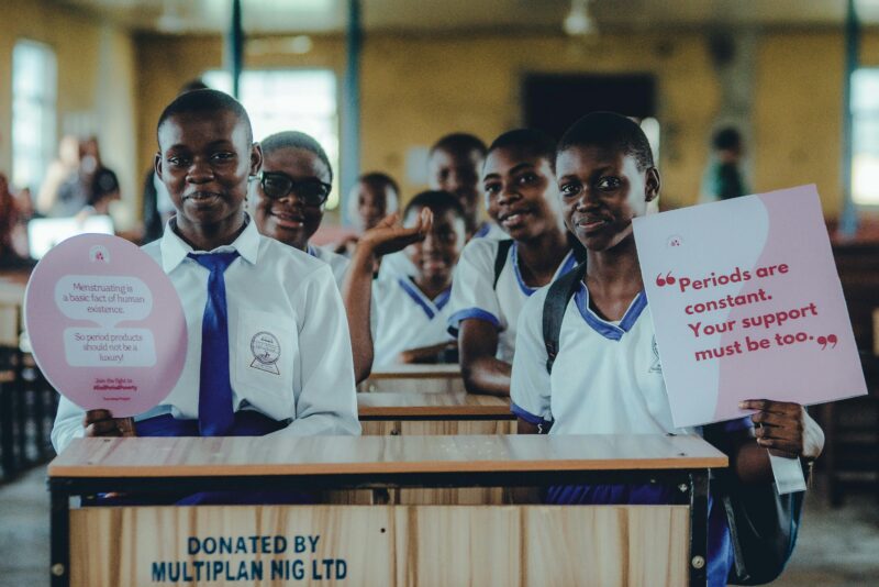 Girls holding signs calling for gender justice.