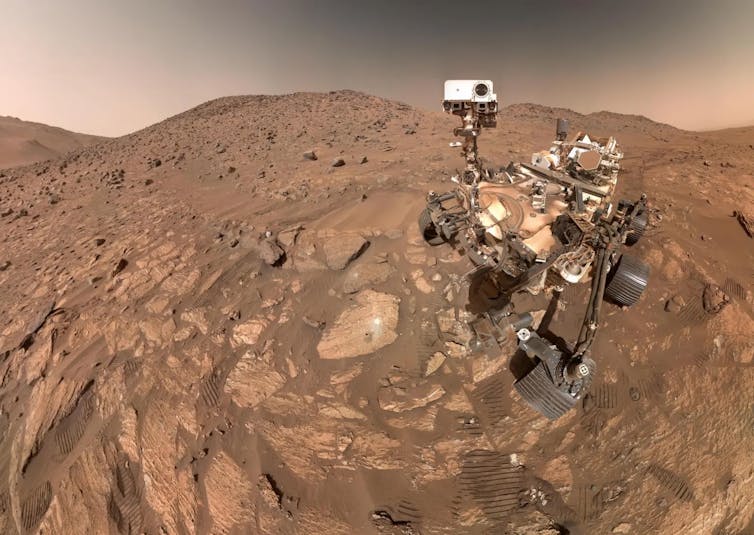 NASA's Perserverance rover on the brown rocky surface of Mars.