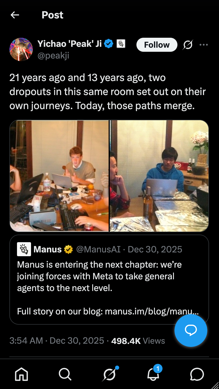 Two people in an office setting, working on laptops at a table, reminiscing about their past and future collaboration.