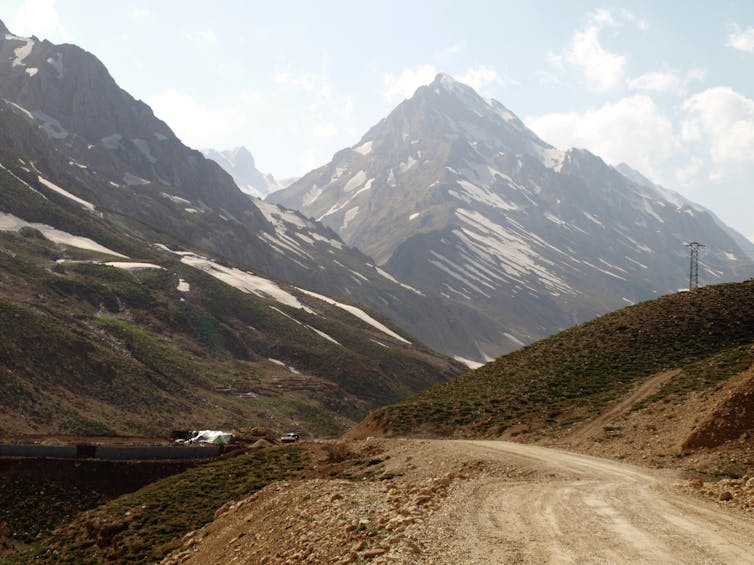 A rural road winding through Iran's Zagros mountain range.