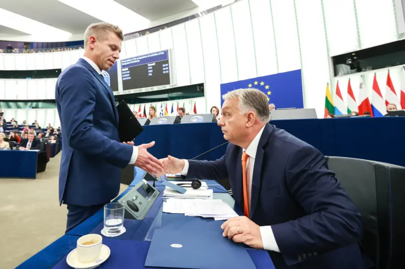 Péter Magyar (standing) and Viktor Orbán in the European Parliament. Photo credit: Alain Rolland, © European Union, 1998 – 2026, attribution license. 