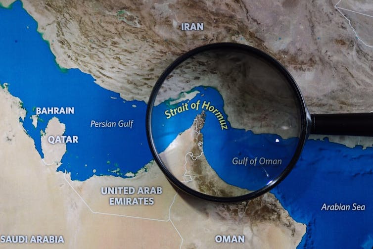Map of Strait of Hormuz with magnifying glass.