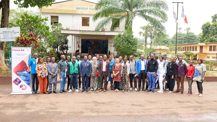 People taking a photo in front of a building