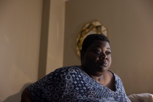 Several large apartment buildings are partially destroyed, with their doors and siding lying in piles in front of them.