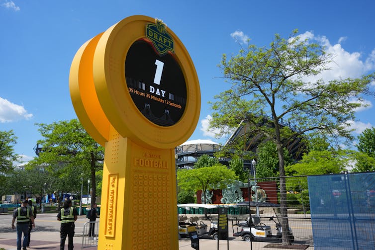 Closeup of a large, yellow countdown clock for the NFL Draft.