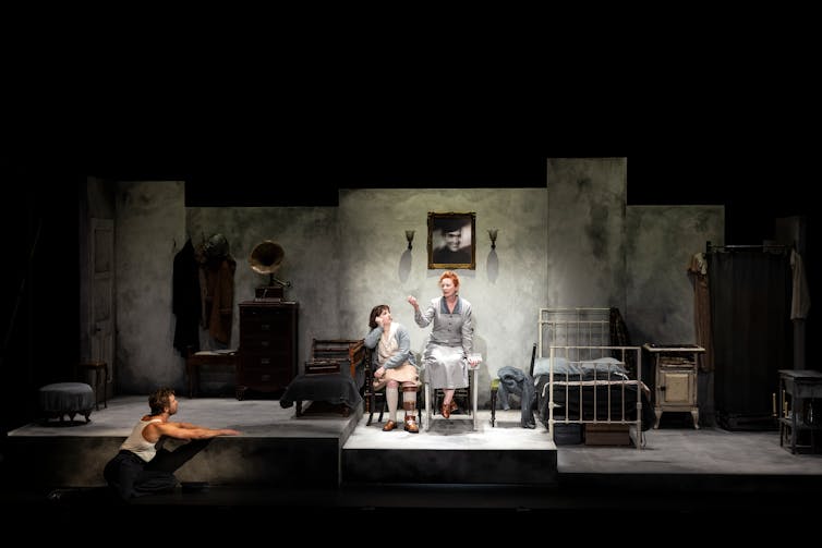 Production image: the family in grey, on a grey set.