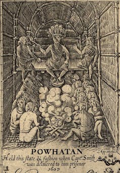 A black and white illustration shows a man in a feather headdress sitting on a platform above a seated crowd.