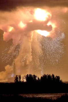 A huge explosion of flame, smoke and showering sparks.