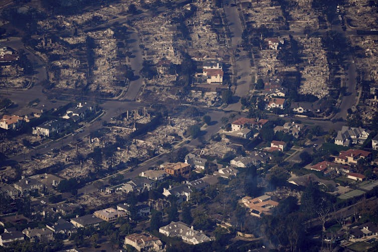 an aerial view of a burned-out neighbourhood