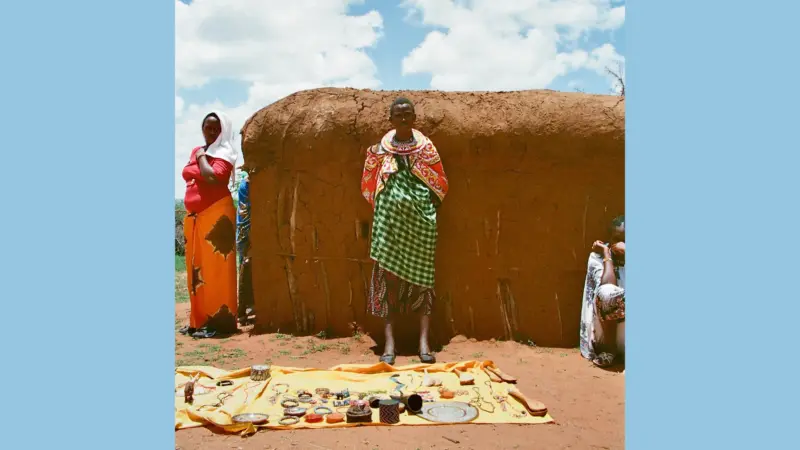 A woman and a man selling beads