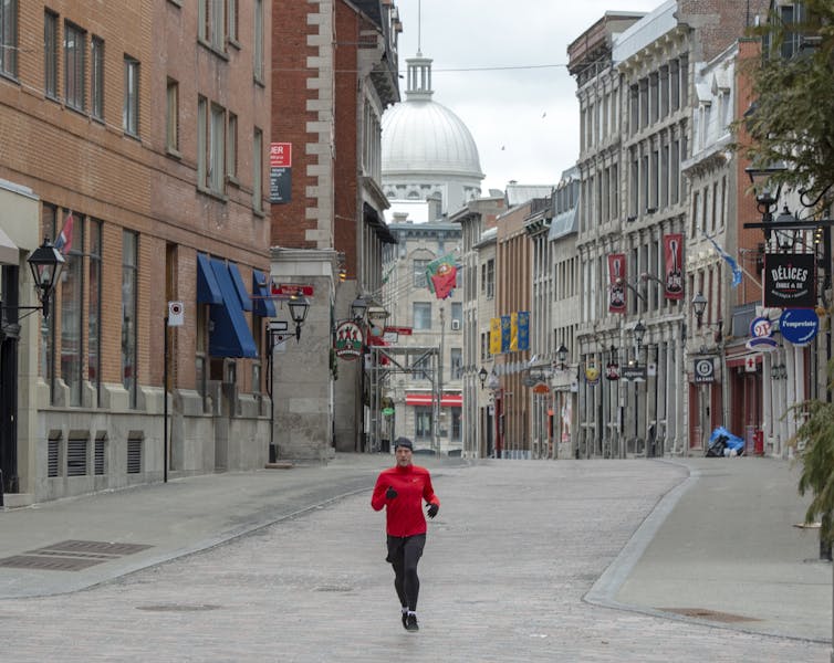 A jogger runs through empty streets