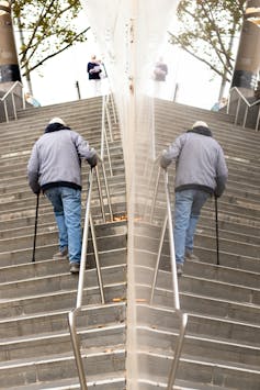 An elderly man climbing stairs