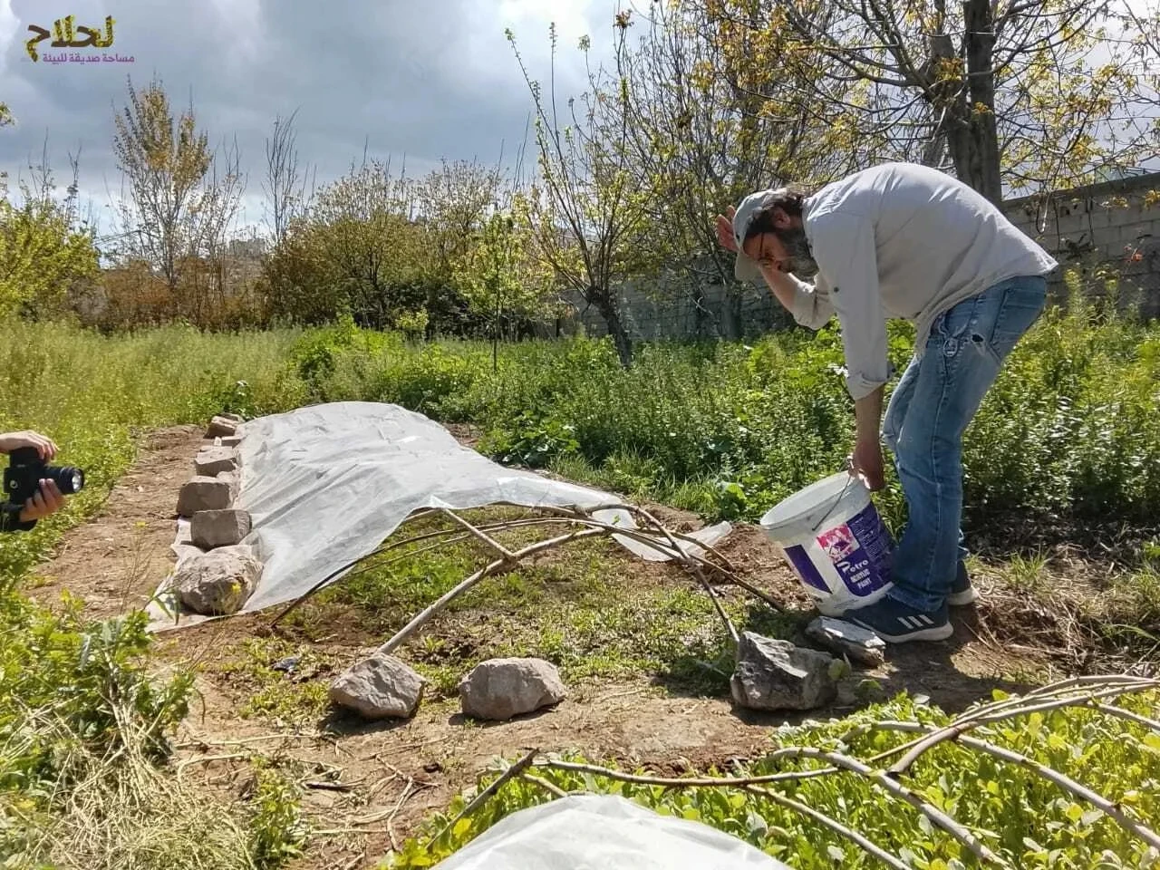 A man is doing agricultural work in a green space