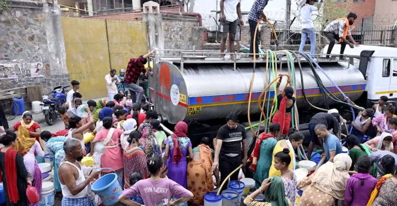 Indian residents cluster around a water tank after a drought dried up local boreholes.