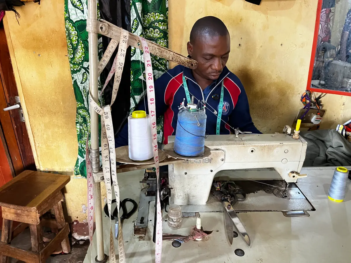 A man sewing with a sewing machine