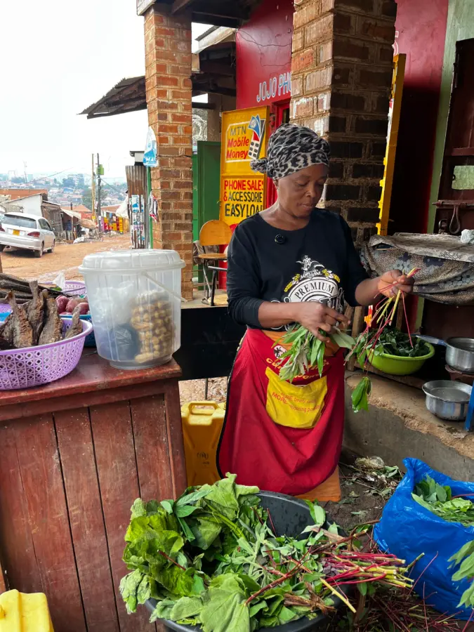 A woman holding green leafy vegetables