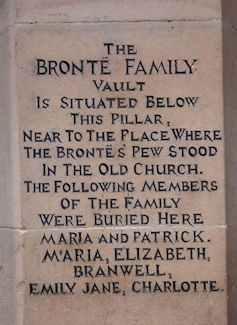 A tomb stone marking the graves of the Brontë children.