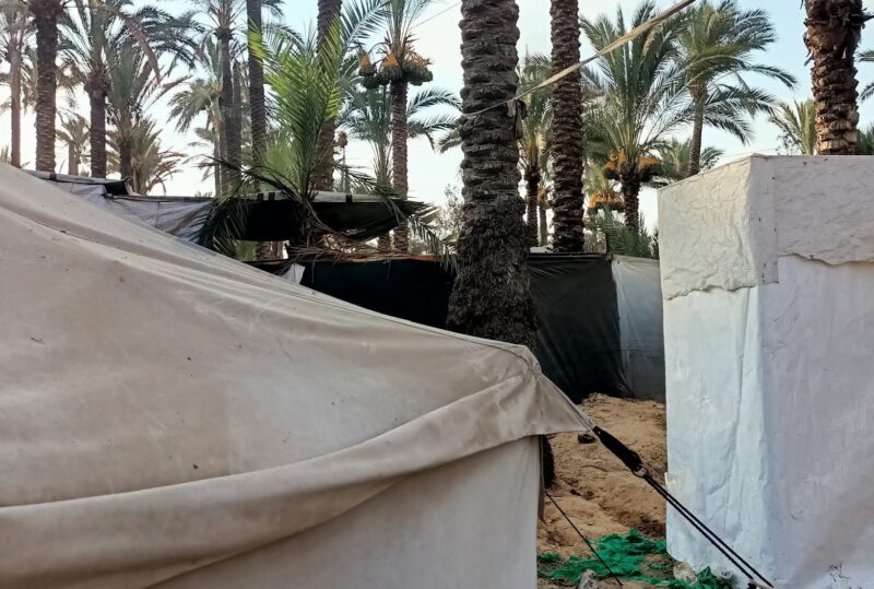 Shelters, including a temporary improvised bathroom set up between the tents. Picture by the author, used with permission.