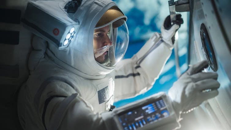 astronaut in spaceship talking to mission control