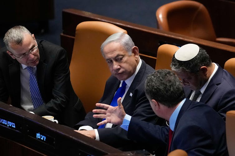 Israeli prime minister, Benjamin Netanyahu, speaks with ministers in the Knesset including national security minister, Itamar Ben Gvir, and minister of defence, Israeli Katz.