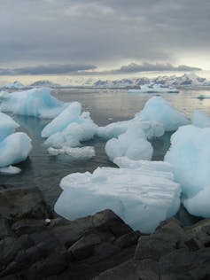 melting white ice on blue sea