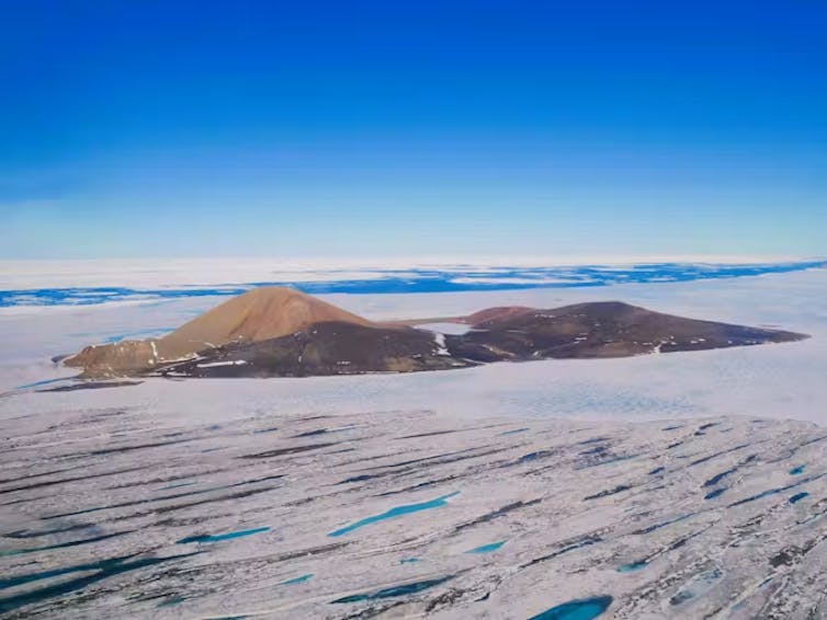 A mountain surrounded by ice.
