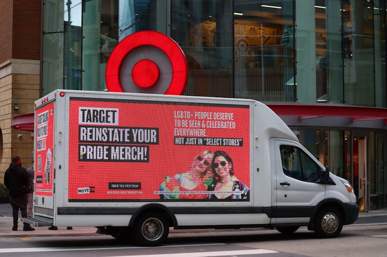 A large truck covered with a billboard saying 'Target, reinstate your Pride merch.'