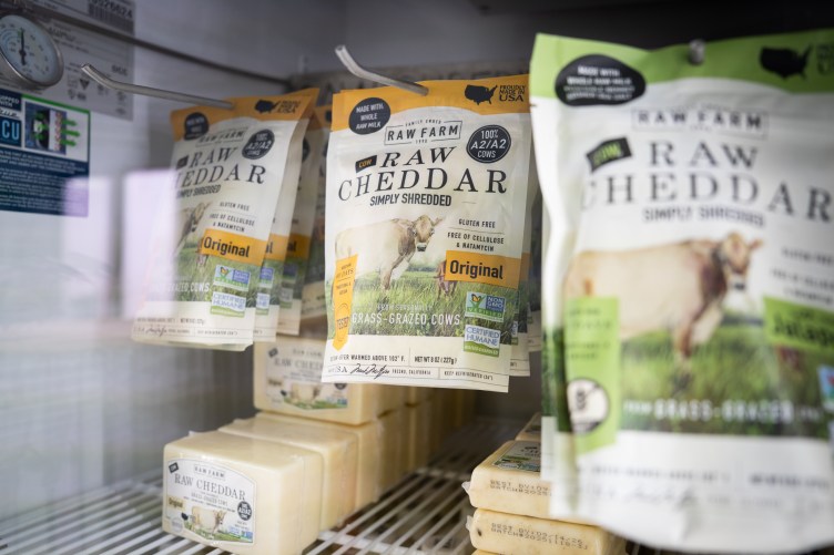 Bags and blocks of Raw Farm brand raw cheddar cheese