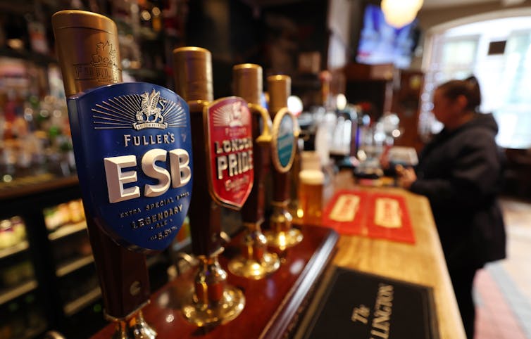 row of beer pumps in a british pub.