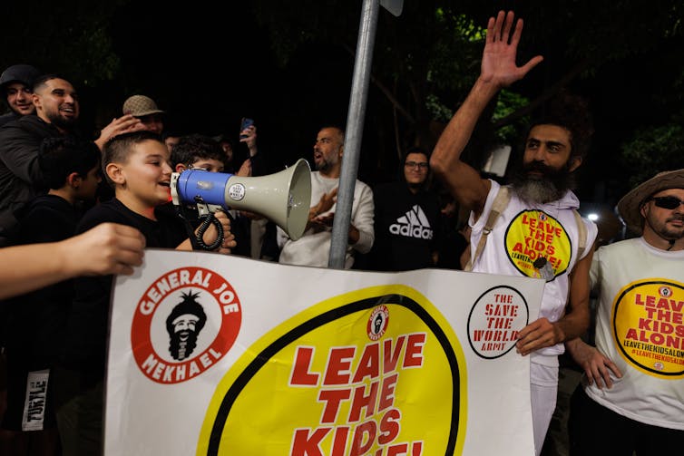 a child speaking into a megaphone at a rally