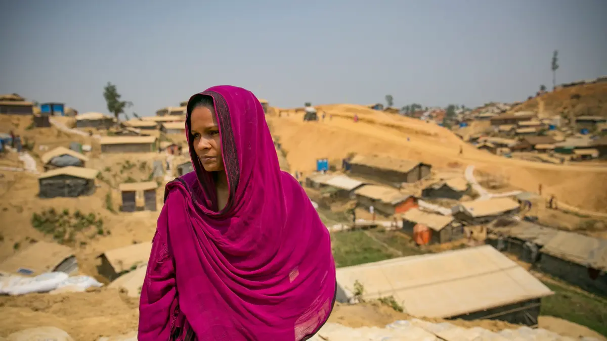 A Rohingya refugee woman stands outside the Women's Centre in Balukhali camp in Cox's Bazar, Bangladesh. Image via Flick by UN Women. CC BY-NC-ND 2.0