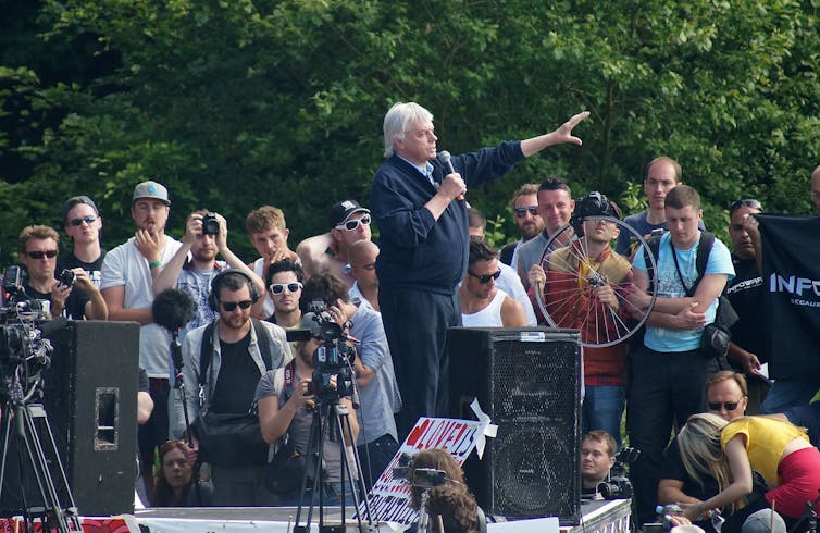 a man on a stage talking to a crowd