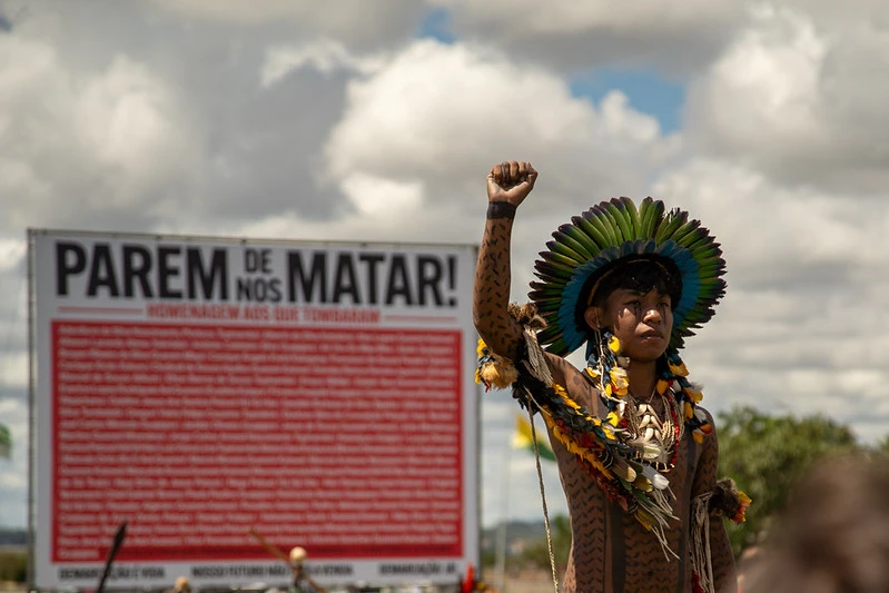 "Stop killing us" says the banner behind a young Indigenous protester during a march