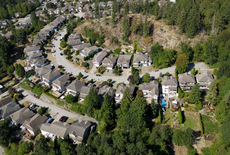 Houses are seen in a neighbourhood on the side of a mountain