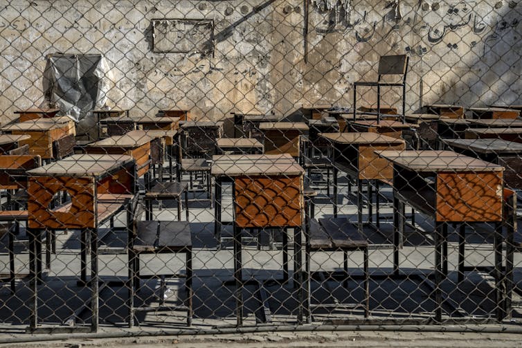 A room filled with empty school desks.