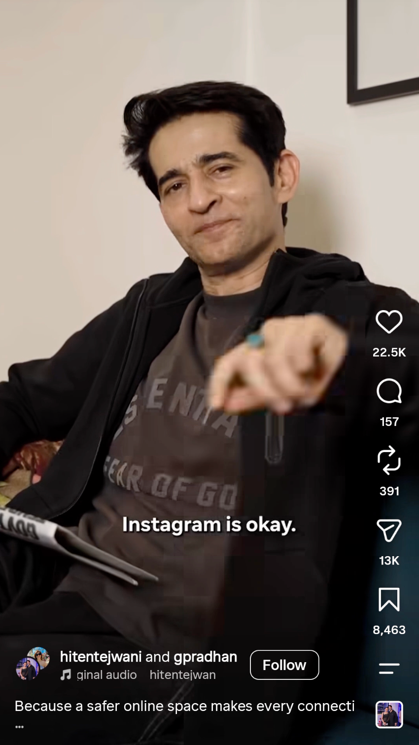 A person in a black jacket smiles and points, saying “Instagram is okay,” as they sit in a casual setting