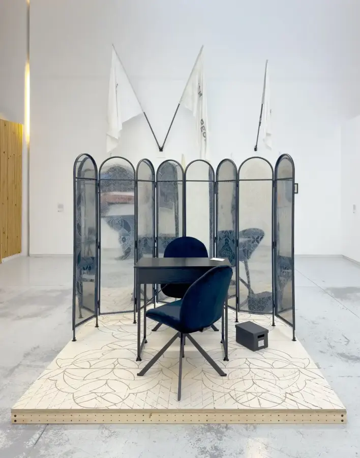 The Archive of Silence was created for the group show The Doorway Effect and exhibited at The Handbag Factory Gallery, London in 2025. Engraved plywood, MDF, timber, metal, UV print on acrylic sheet, magnet, one-way mirror sheet, two chairs, a table, a photo, an archival box. 210 x 210 x 185 cm. 2025. 