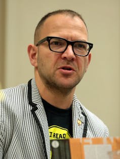 man in glasses and striped blazer